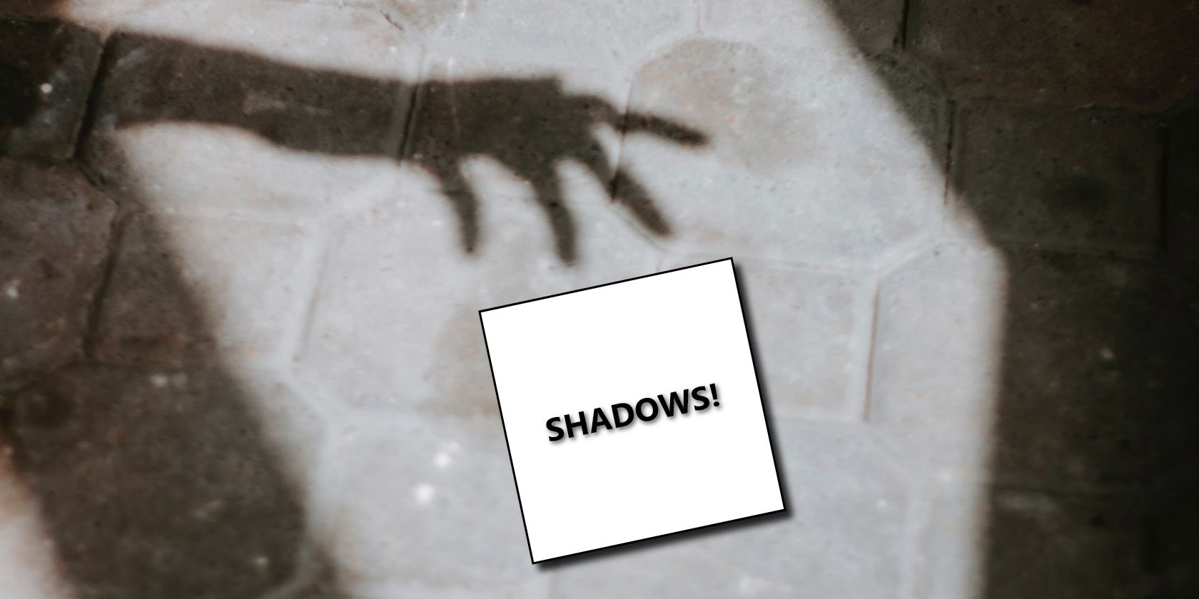 A silhouette of a person's hand with a box containing the word 'shadows'