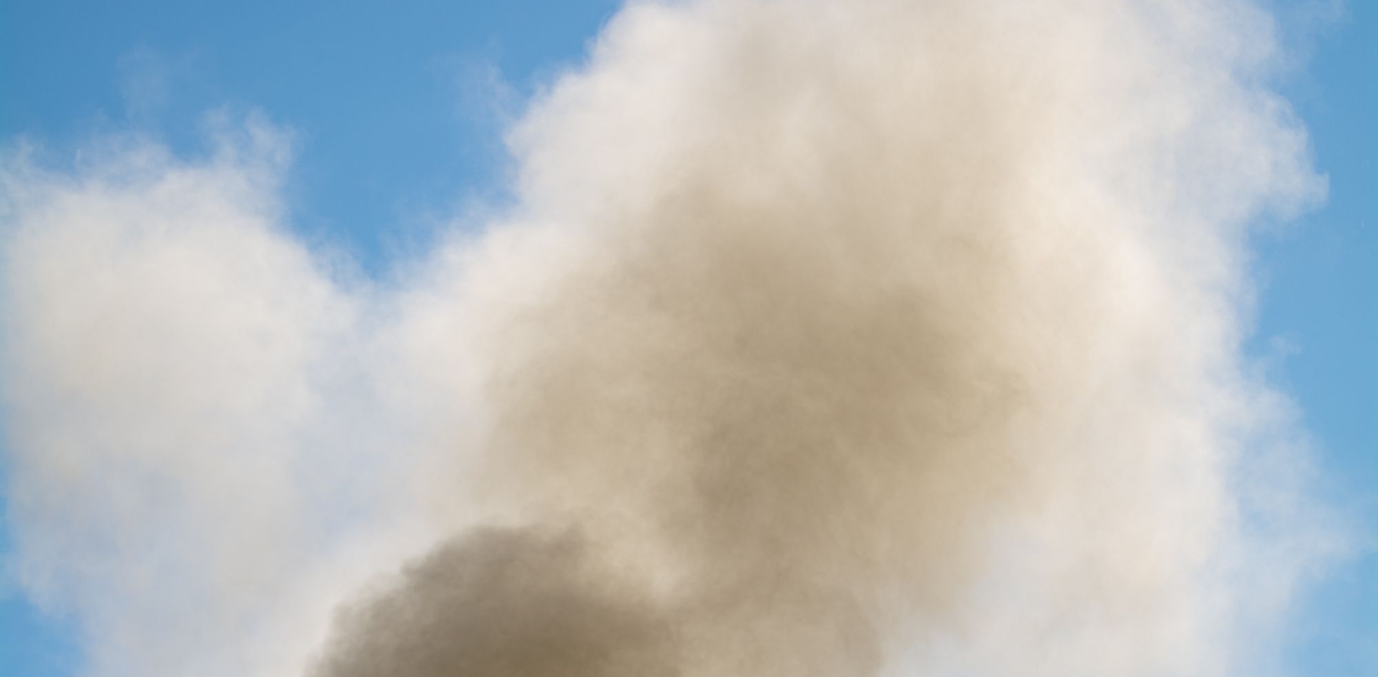 dust cloud in front of blue sky