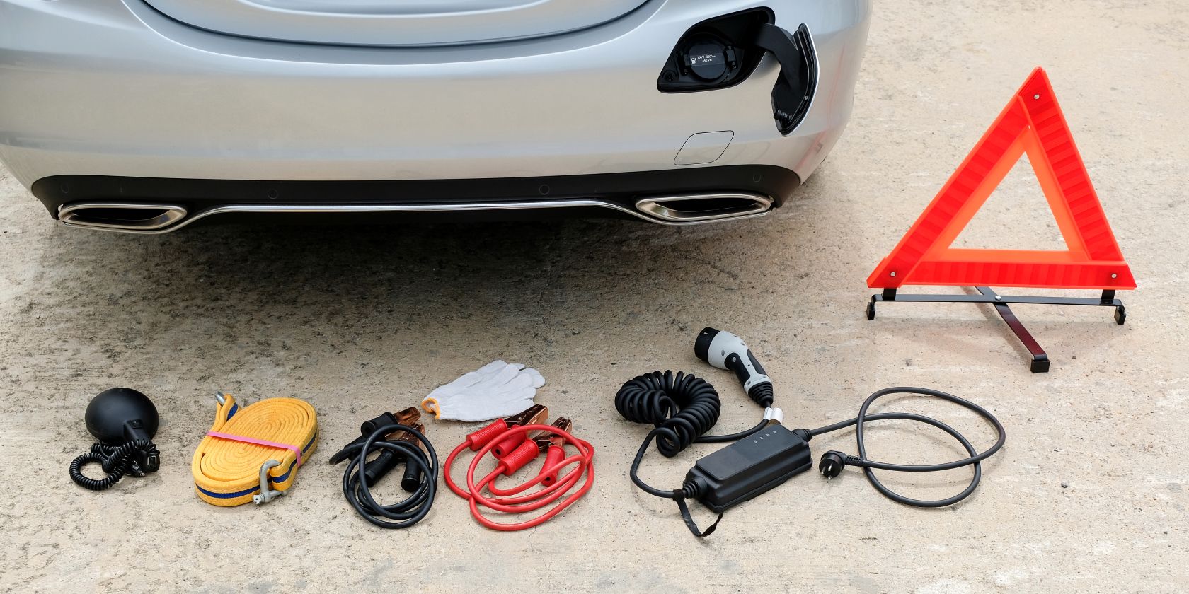 electric vehicle broken down with red triangle and charging cable feature