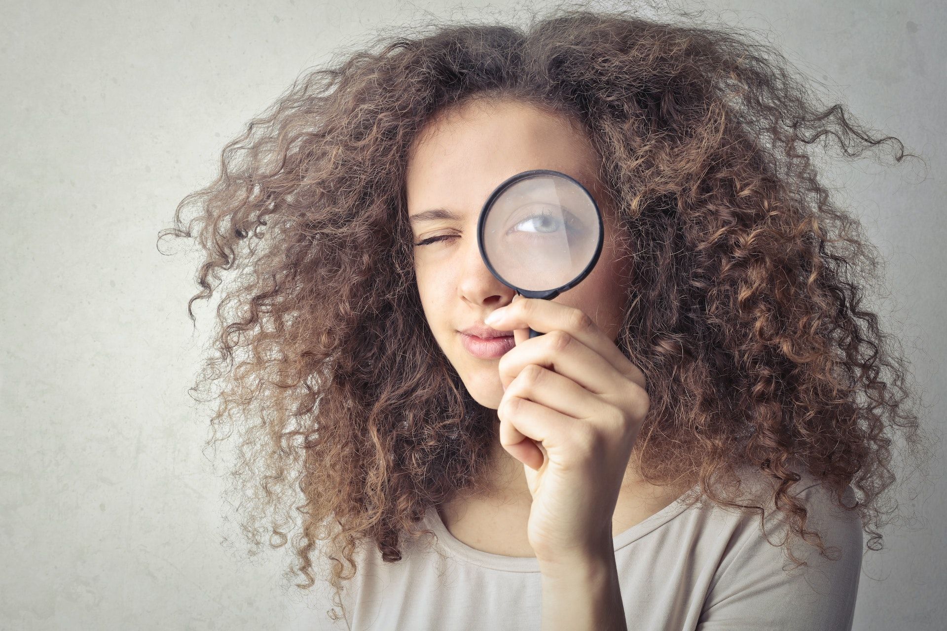 Girl Looking Through Magnifying Glass