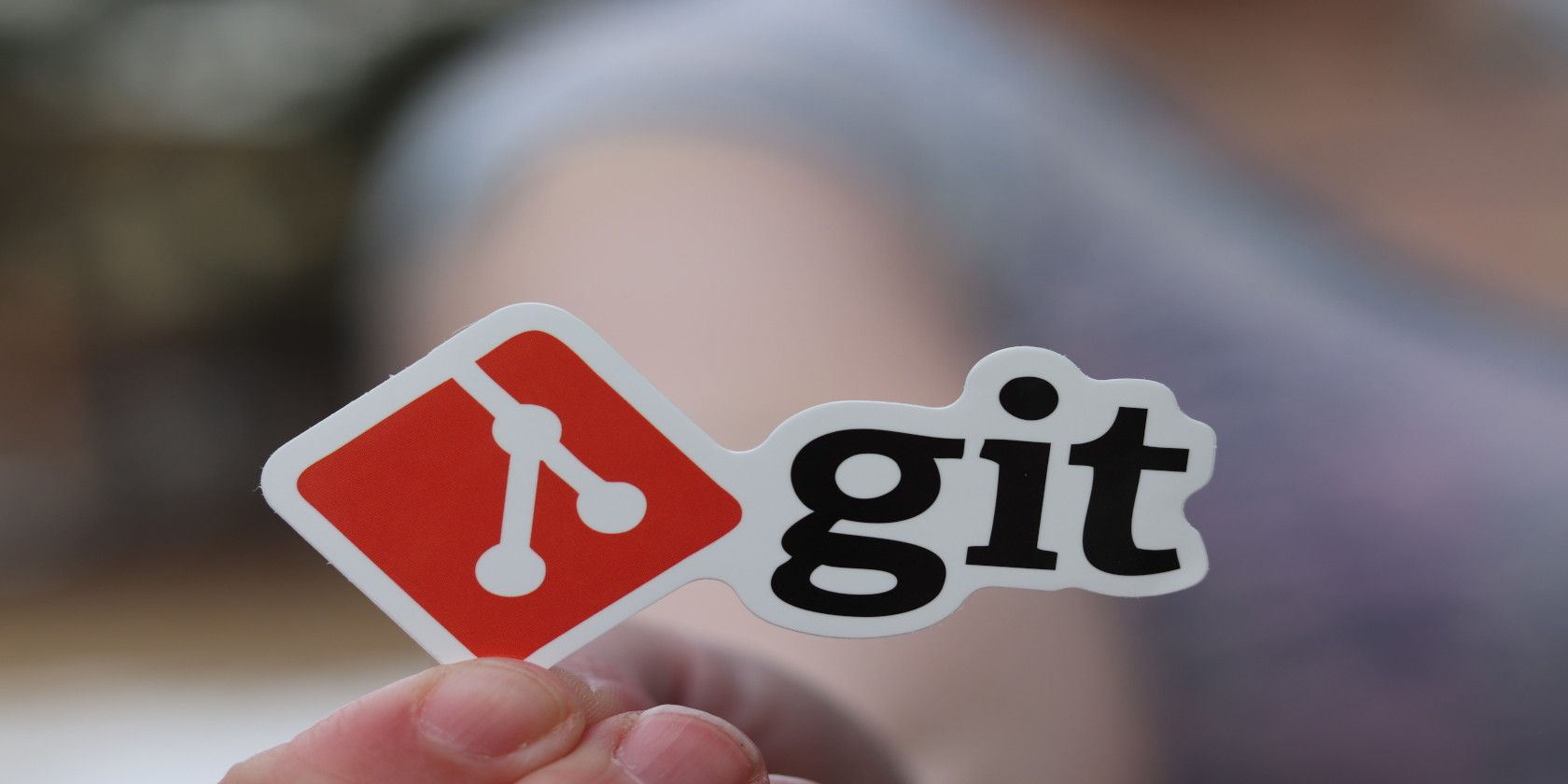 hand holding Git logo