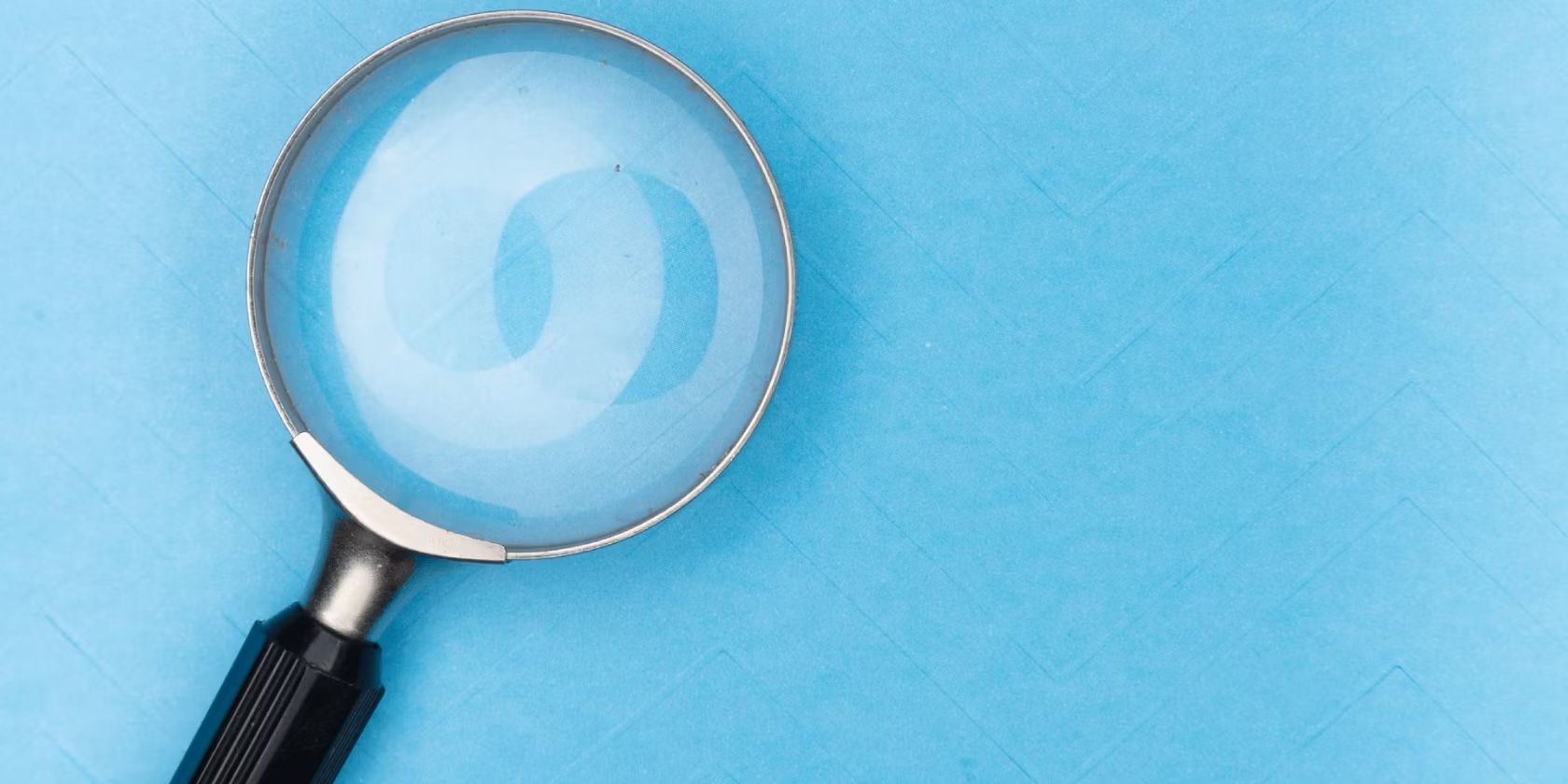 a magnifying glass on a light blue background