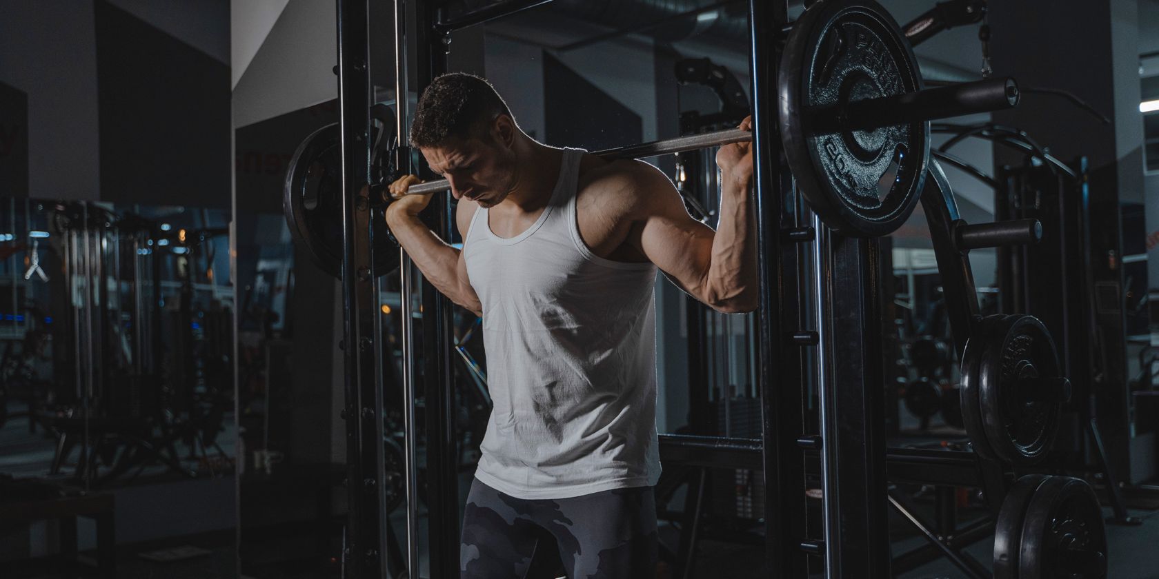 man in vest working out in the gym