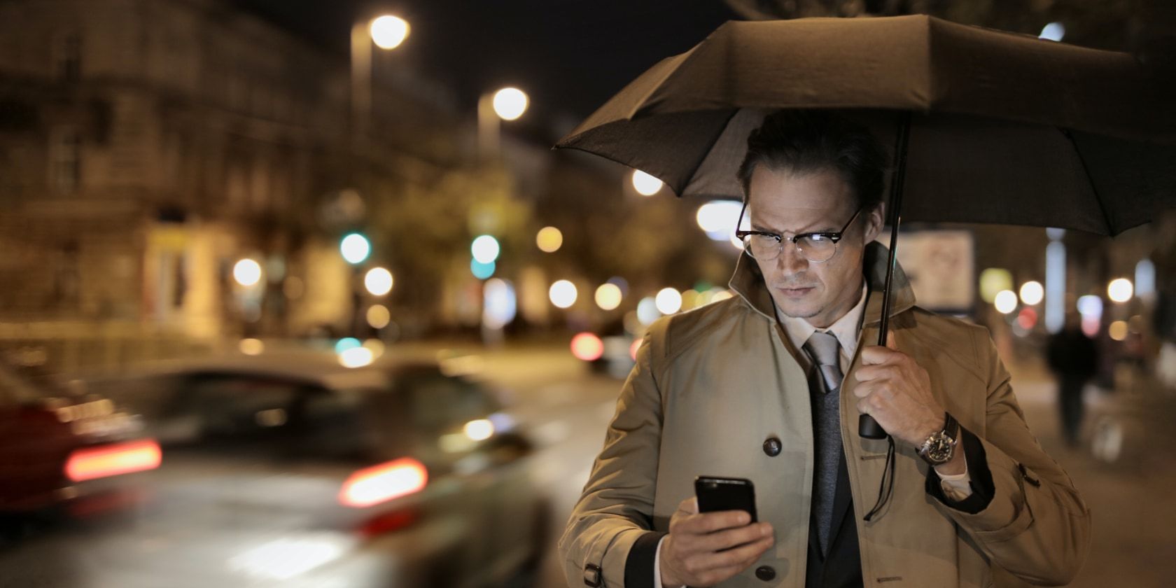 man using phone in rain