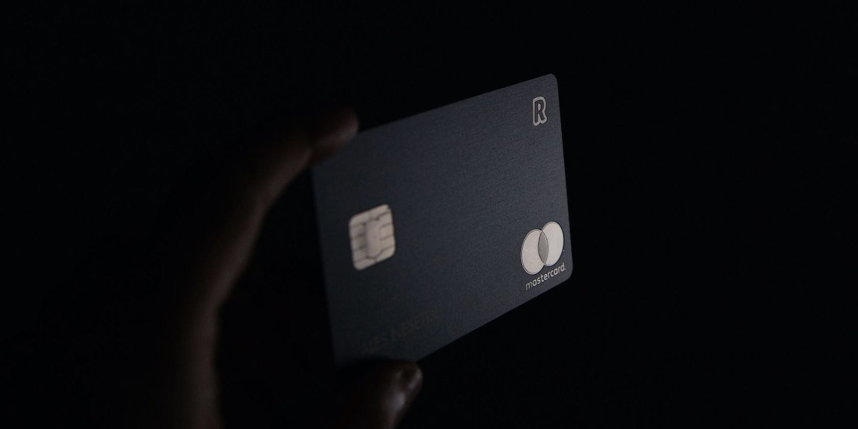 person holding black master card