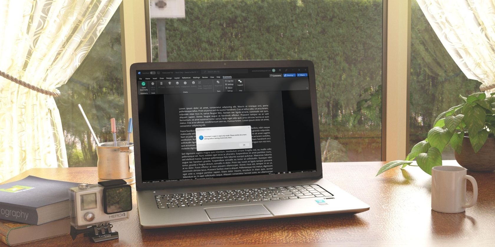 Mockup of a Laptop on Table with Books