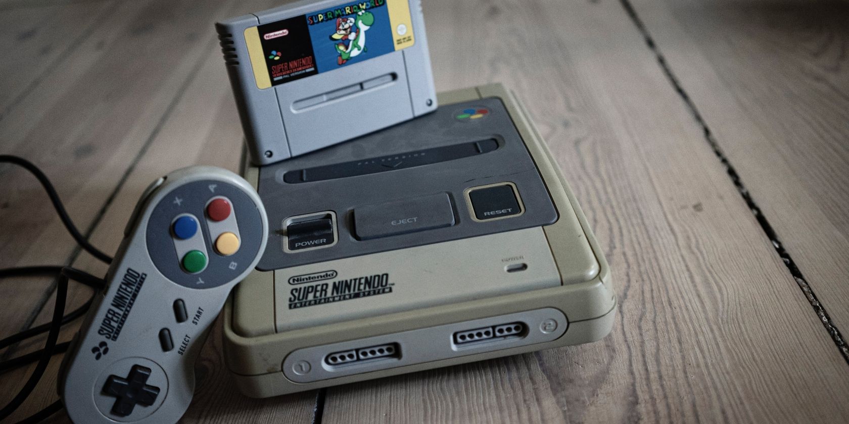 old super nintendo game controller and cartridge