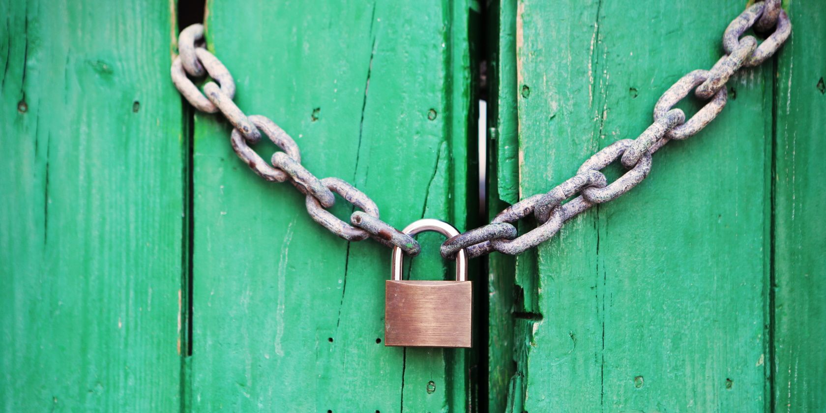 padlock with chain on green door