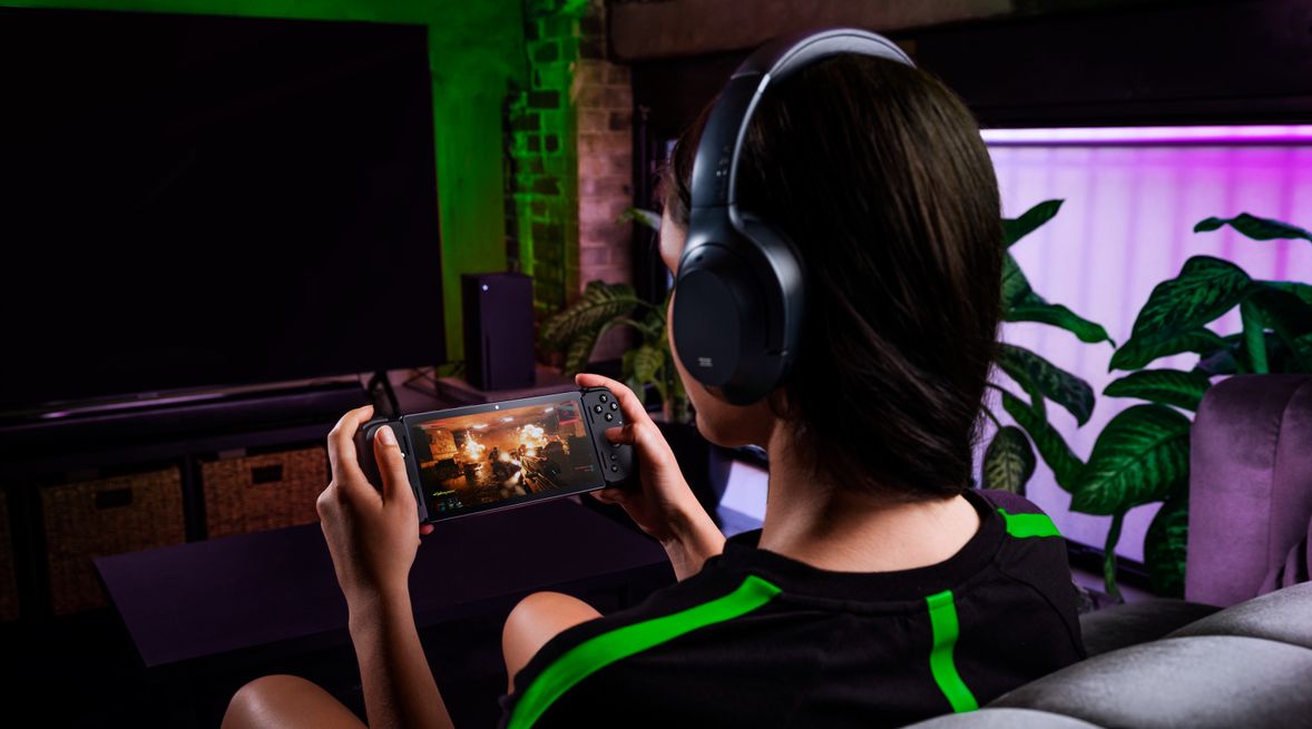 person playing razer edge 5g wearing headphones