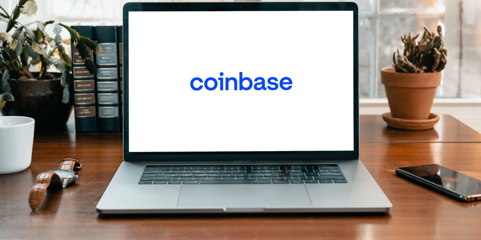 picture of white laptop screen with coinbase written in blue