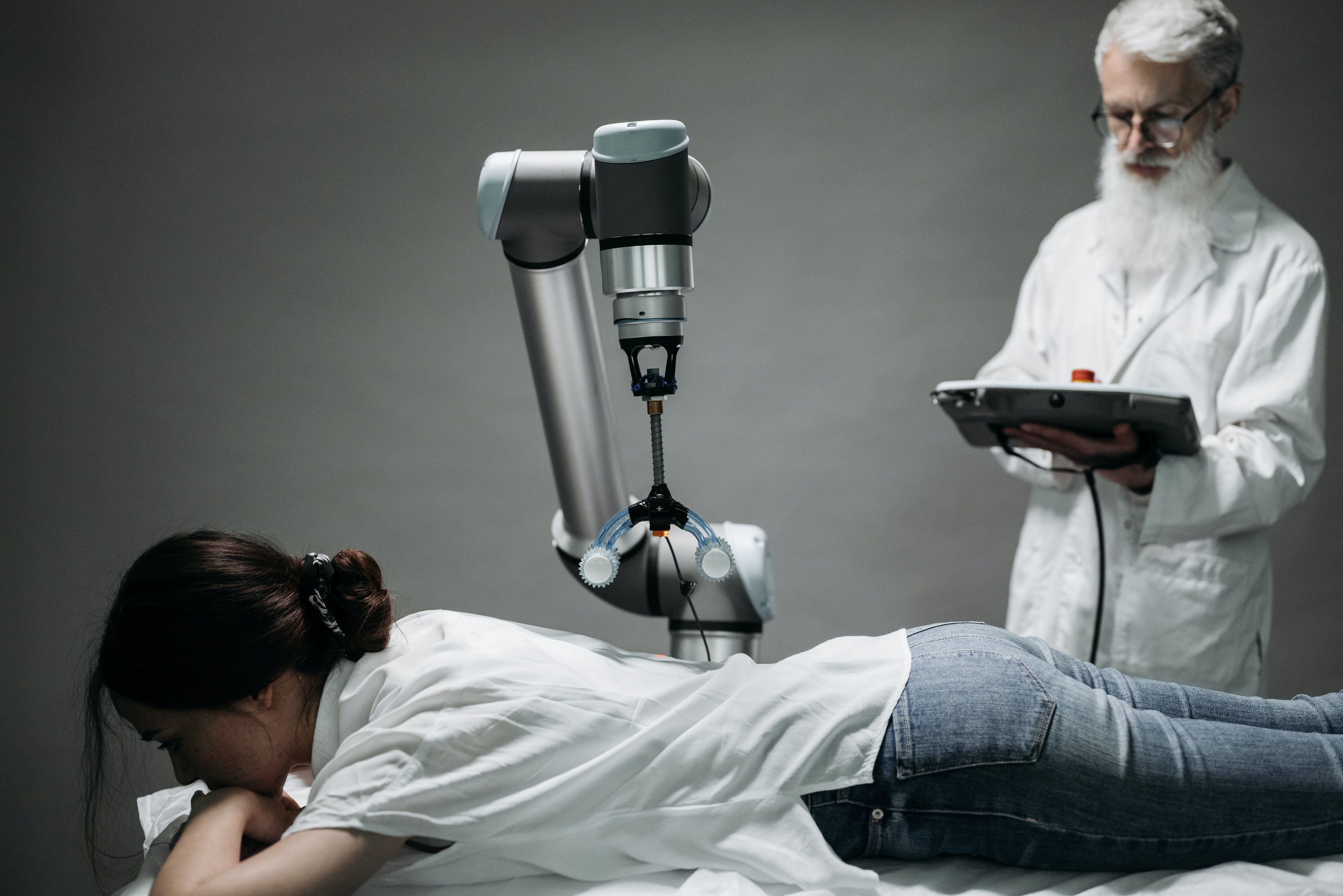 A doctor uses a robot to treat a patient