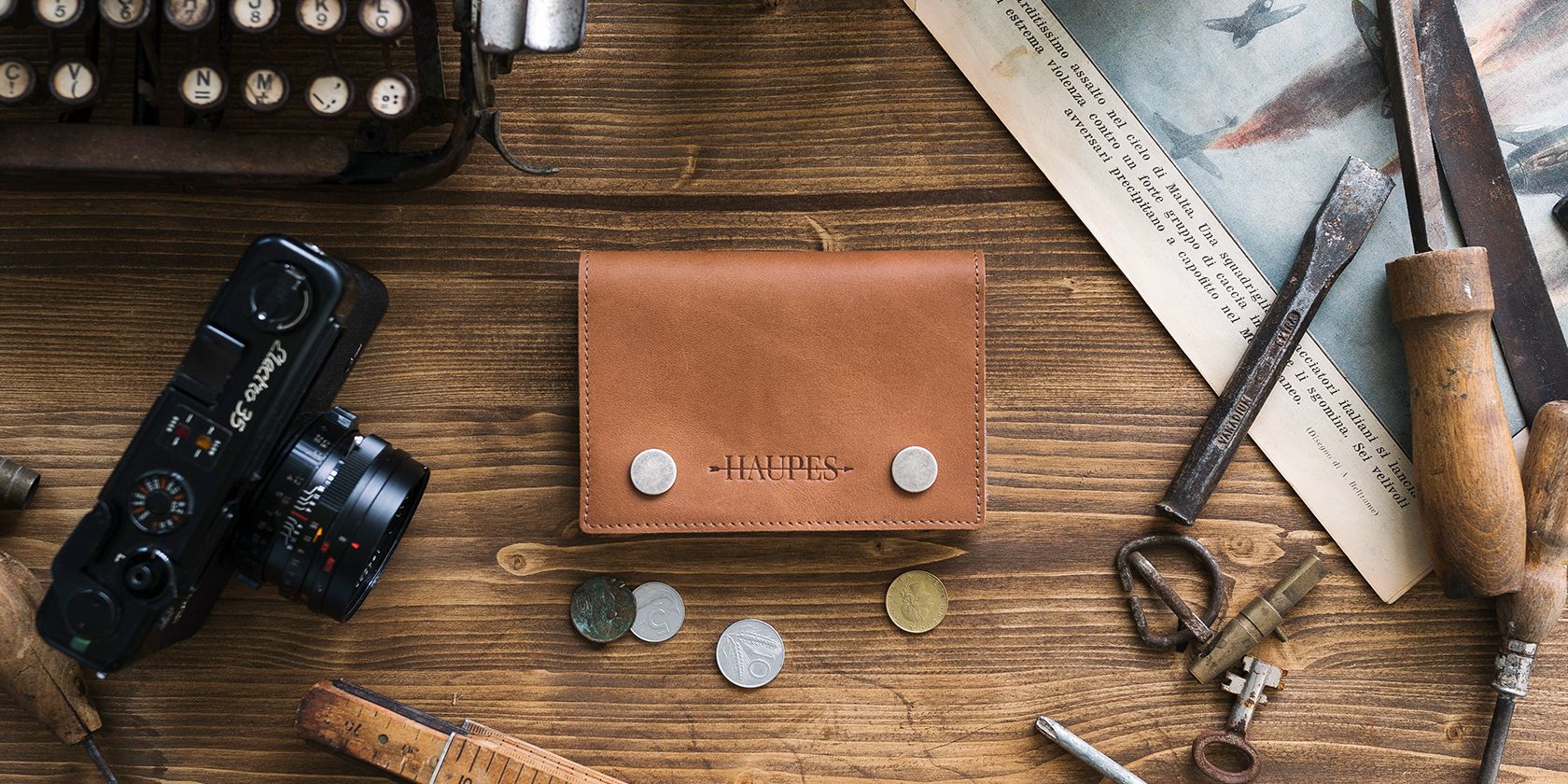 wallet flat lay photo with a camera and some coins