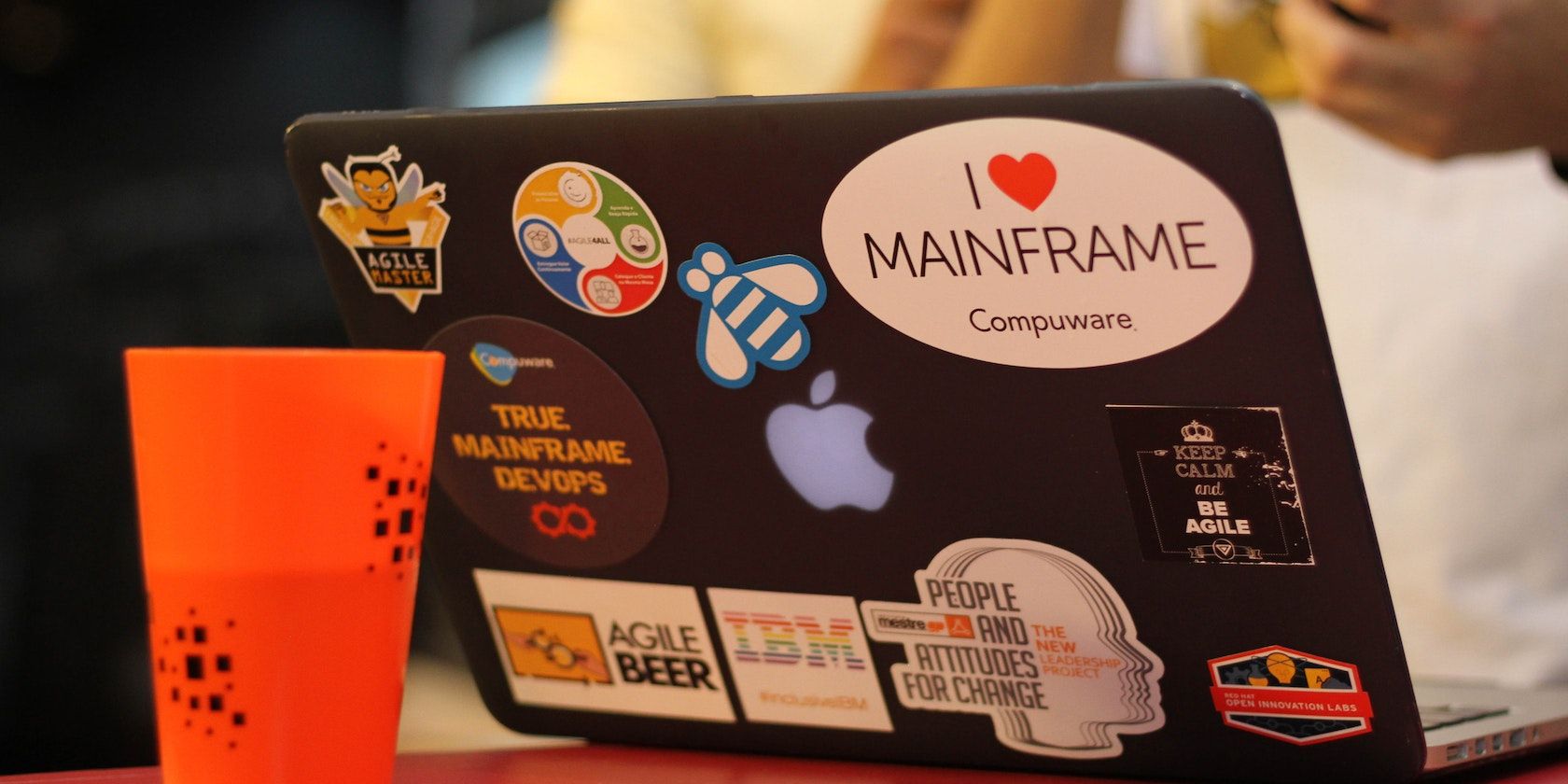 An Image of a laptop covered with DevOps & Agile stickers project management approach