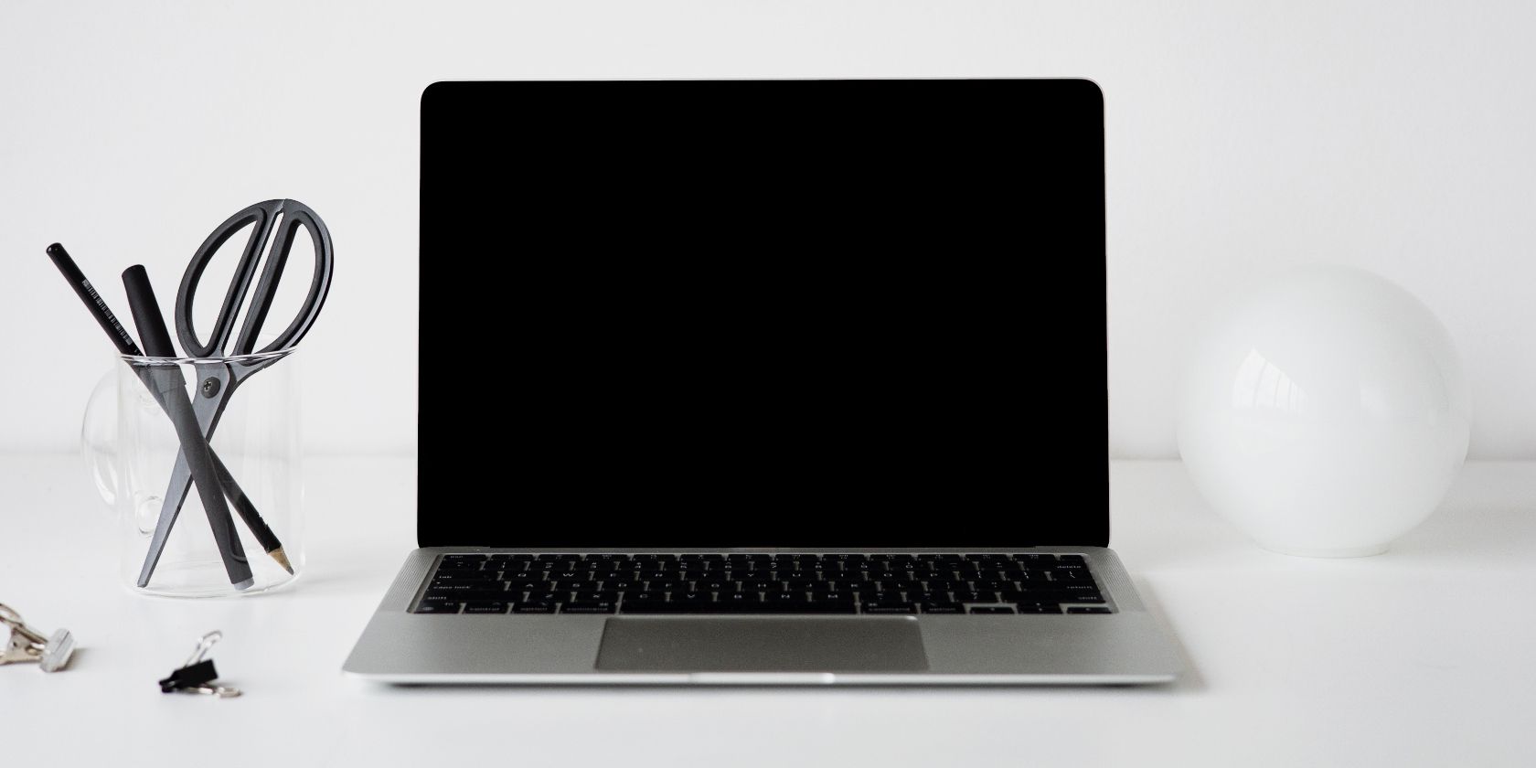 Blank MacBook screen on a white desk