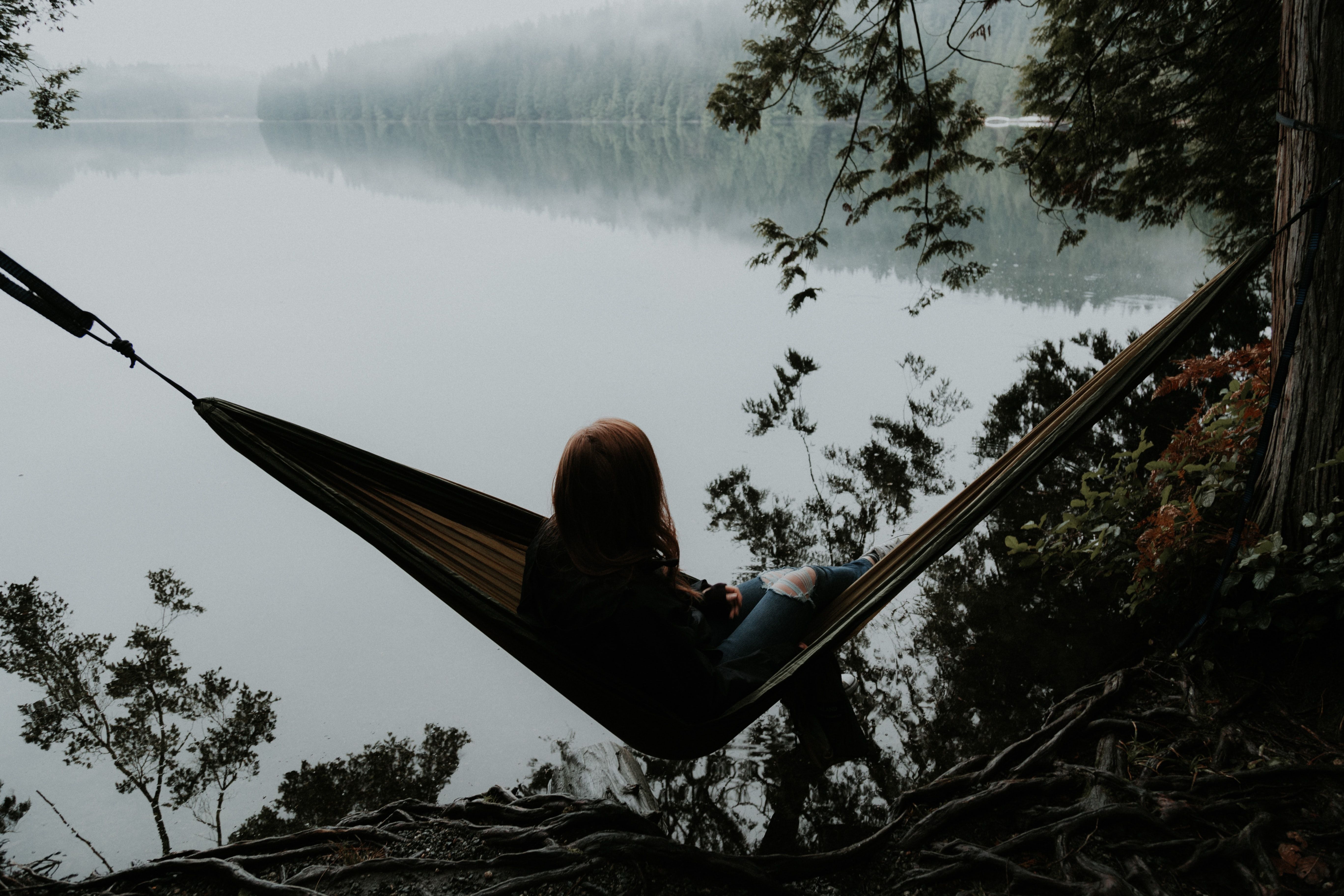 Woman in a hammock by a lake
