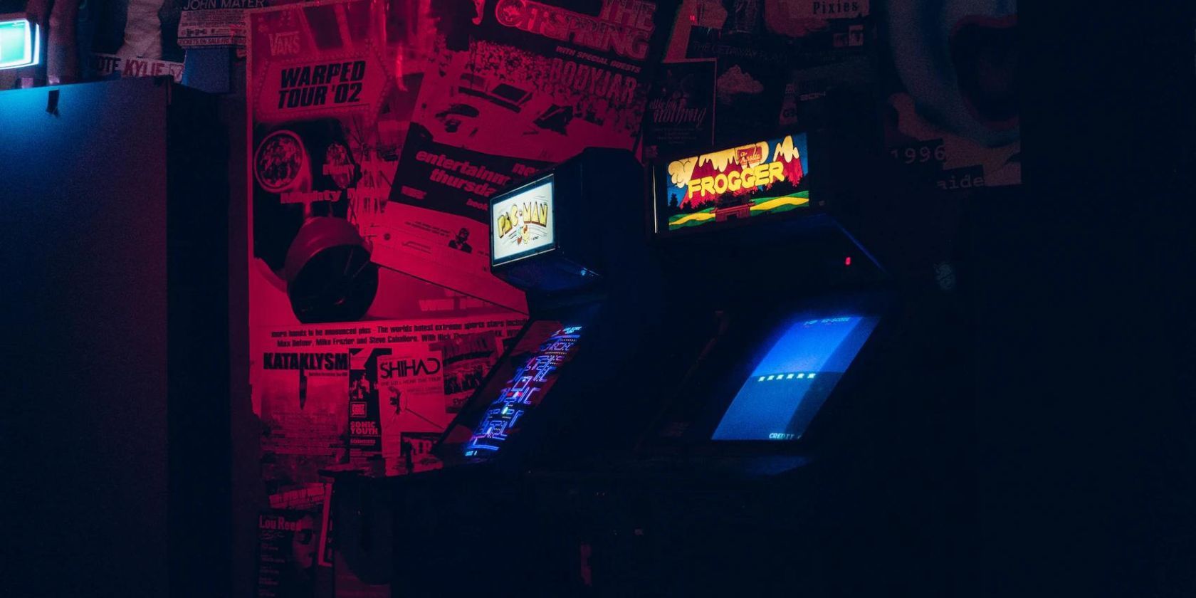 Dimly lit shot of two retro arcade games