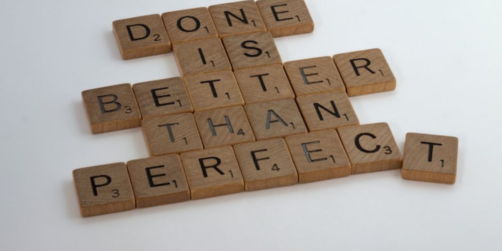 Done is better than perfect,” written with Scrabble tiles.
