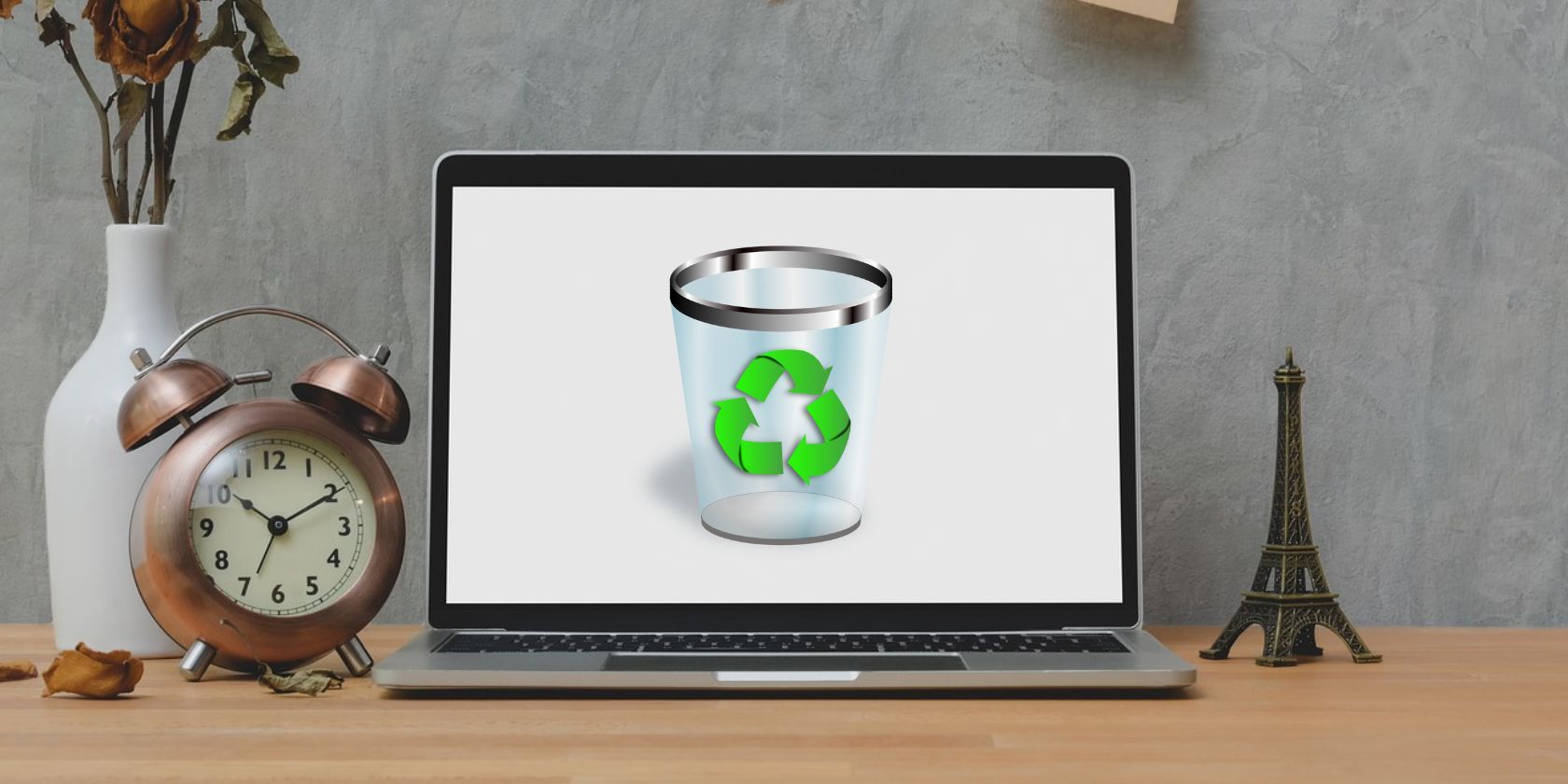 A laptop on a table showing recycle bin logo