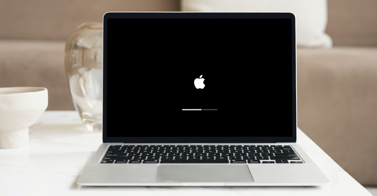 MacBook booting up on white table