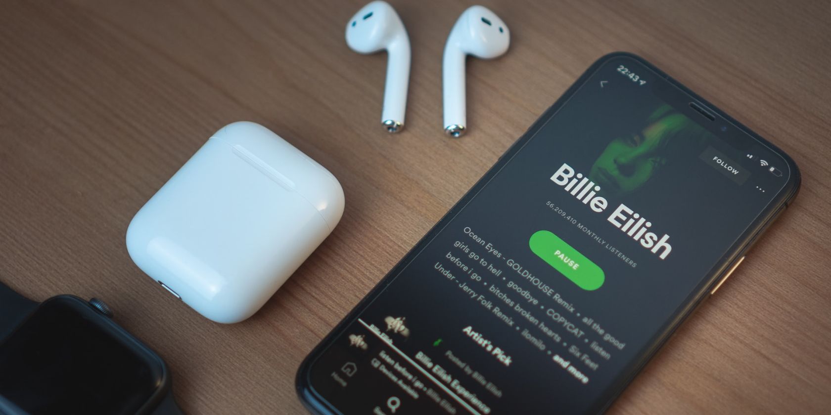 Spotify on iPhone next to AirPods