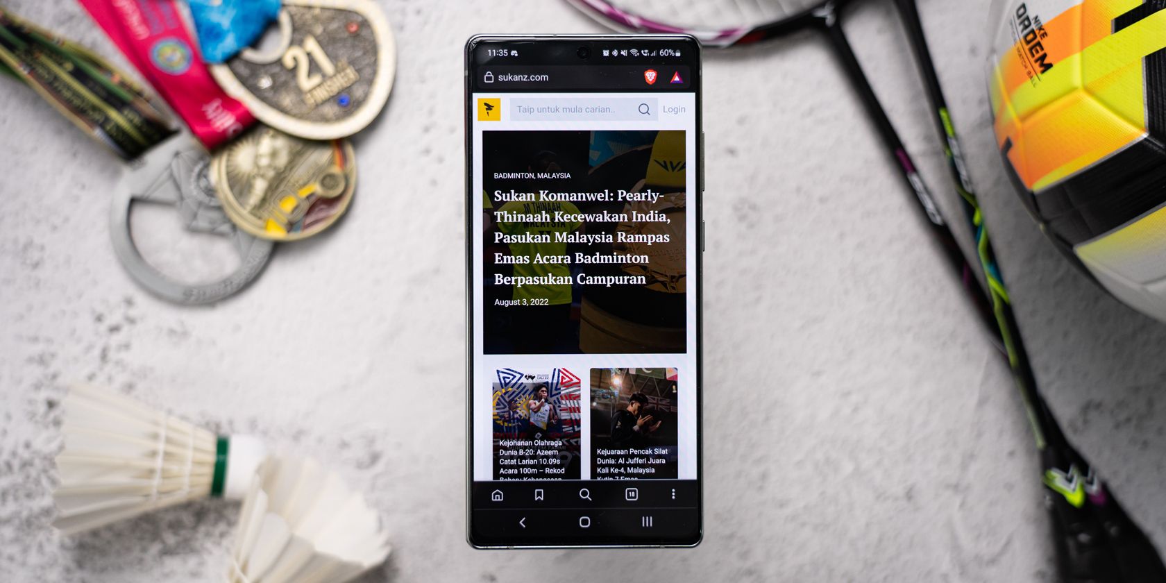 Smartphone on a table with news articles loaded on screen