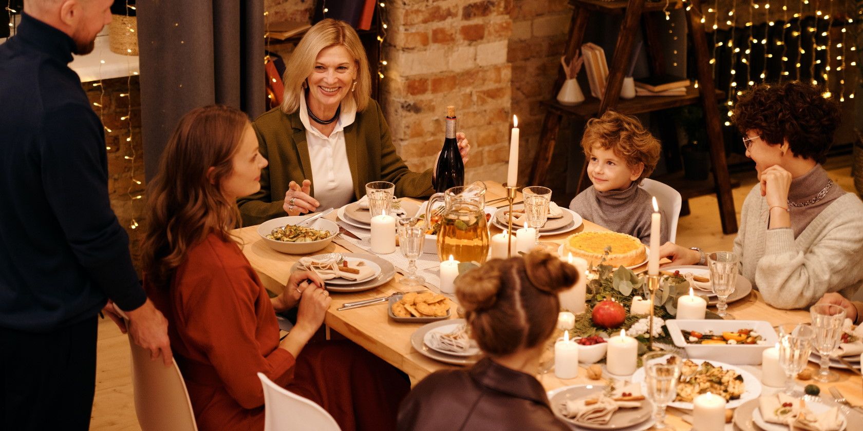 Family eating dinner at table and celebrating holiday season