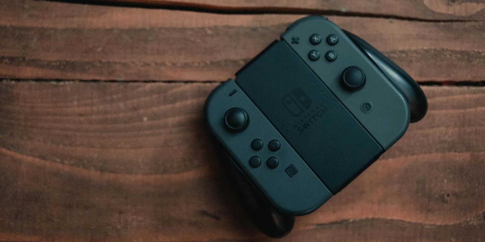 Close up of black Nintendo Switch Joy Cons on a wooden table