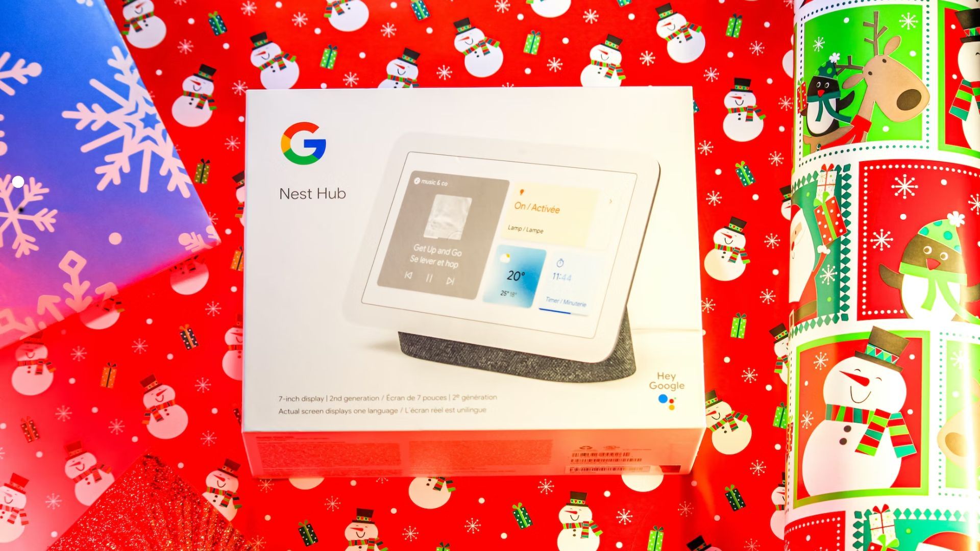 google nest hub in a box on top of holiday wrapping paper