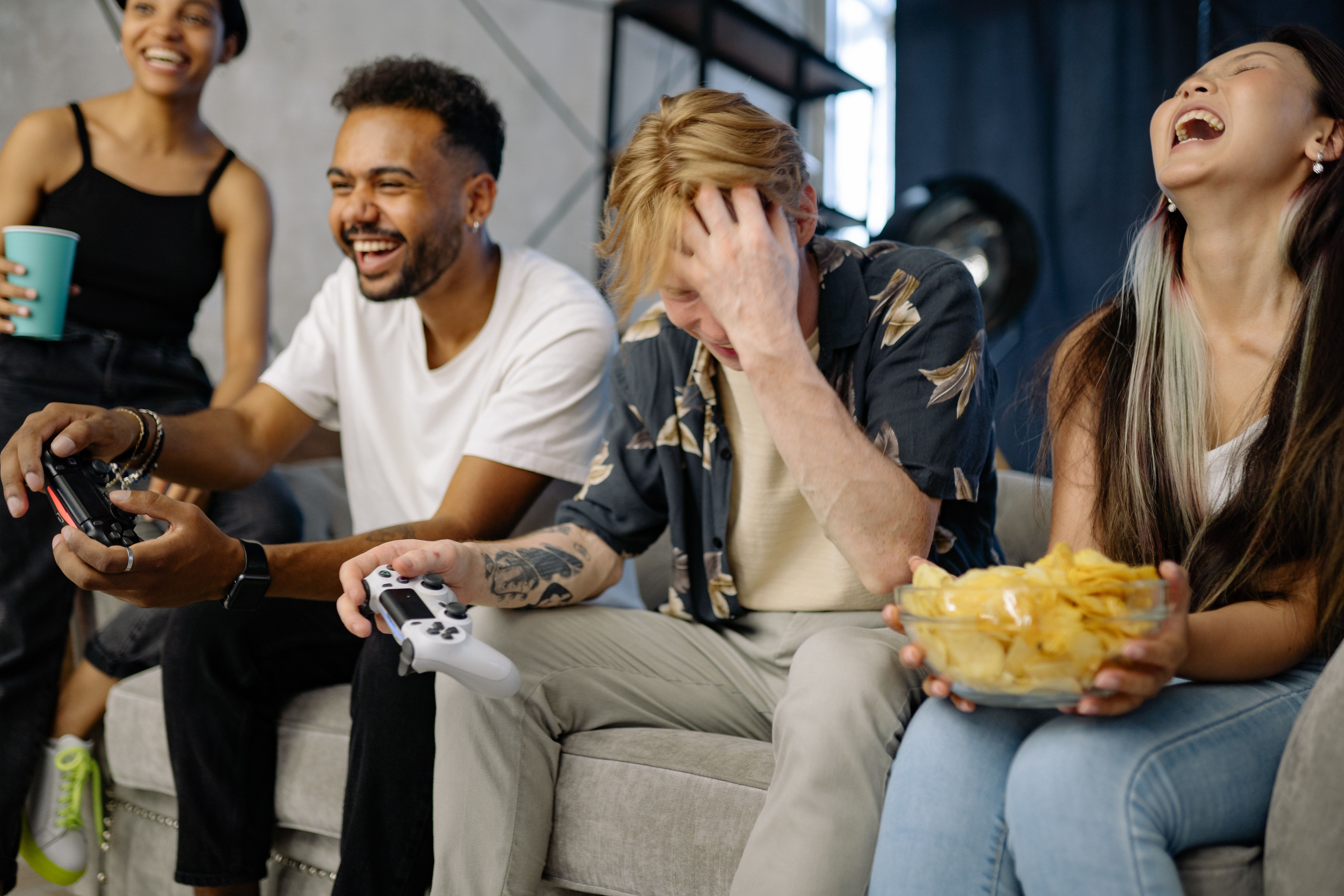 photo of happy friends playing video games