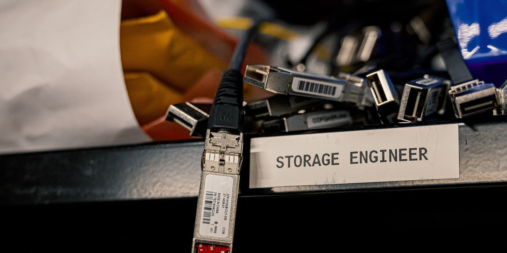 Set of modern cables and connectors next to a label reading “Storage engineer”