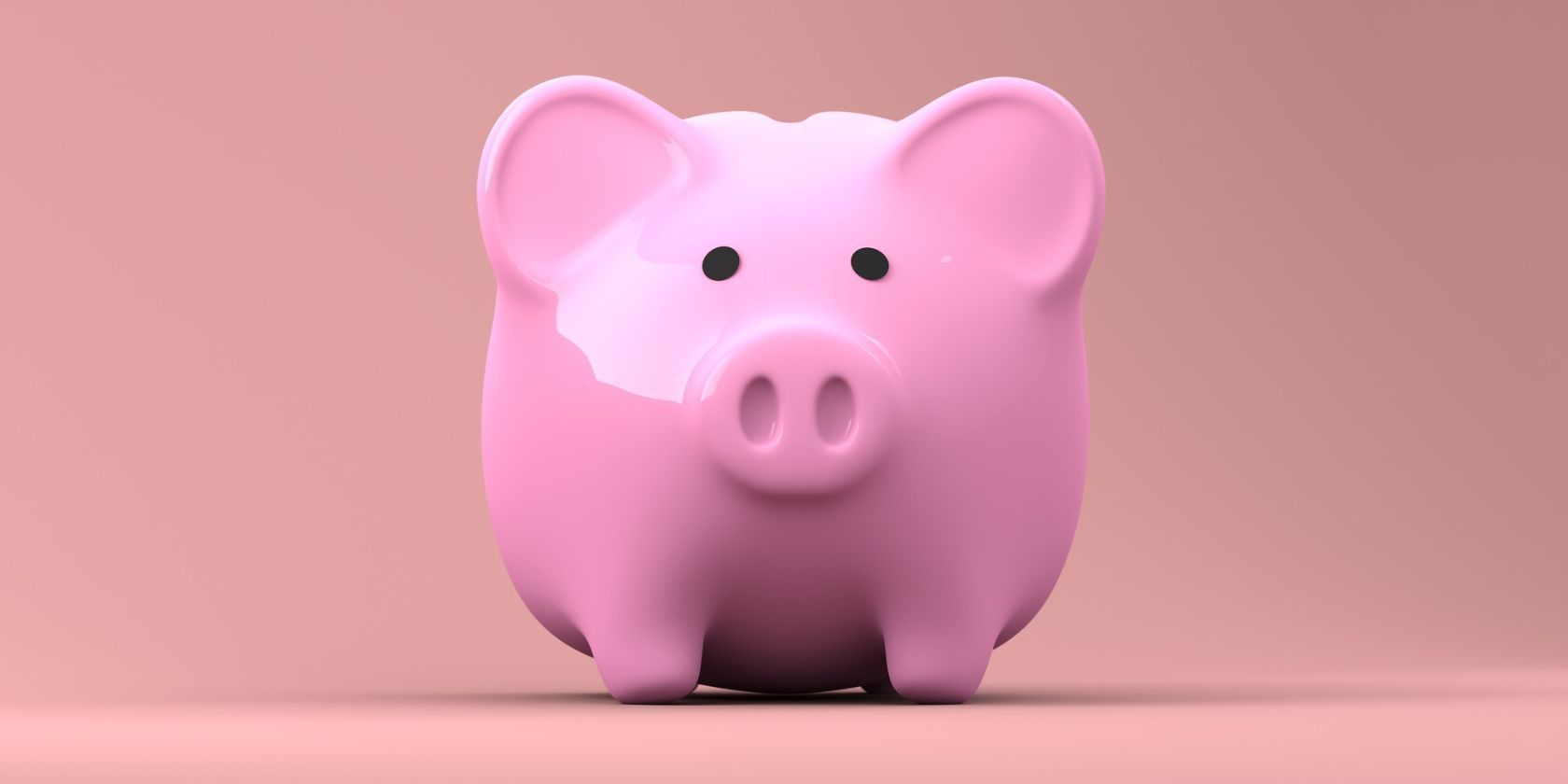 A piggy bank with a pink background