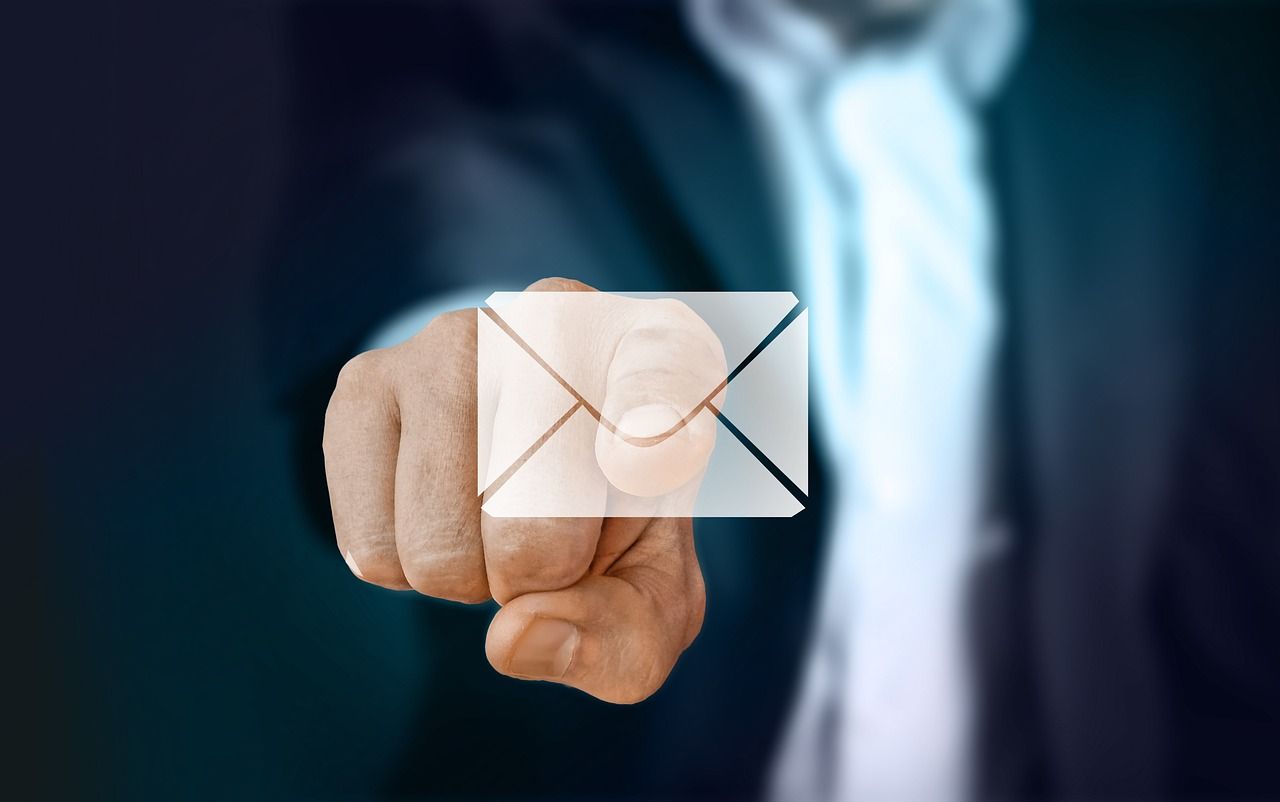 A man stretching out to touch an email icon 
