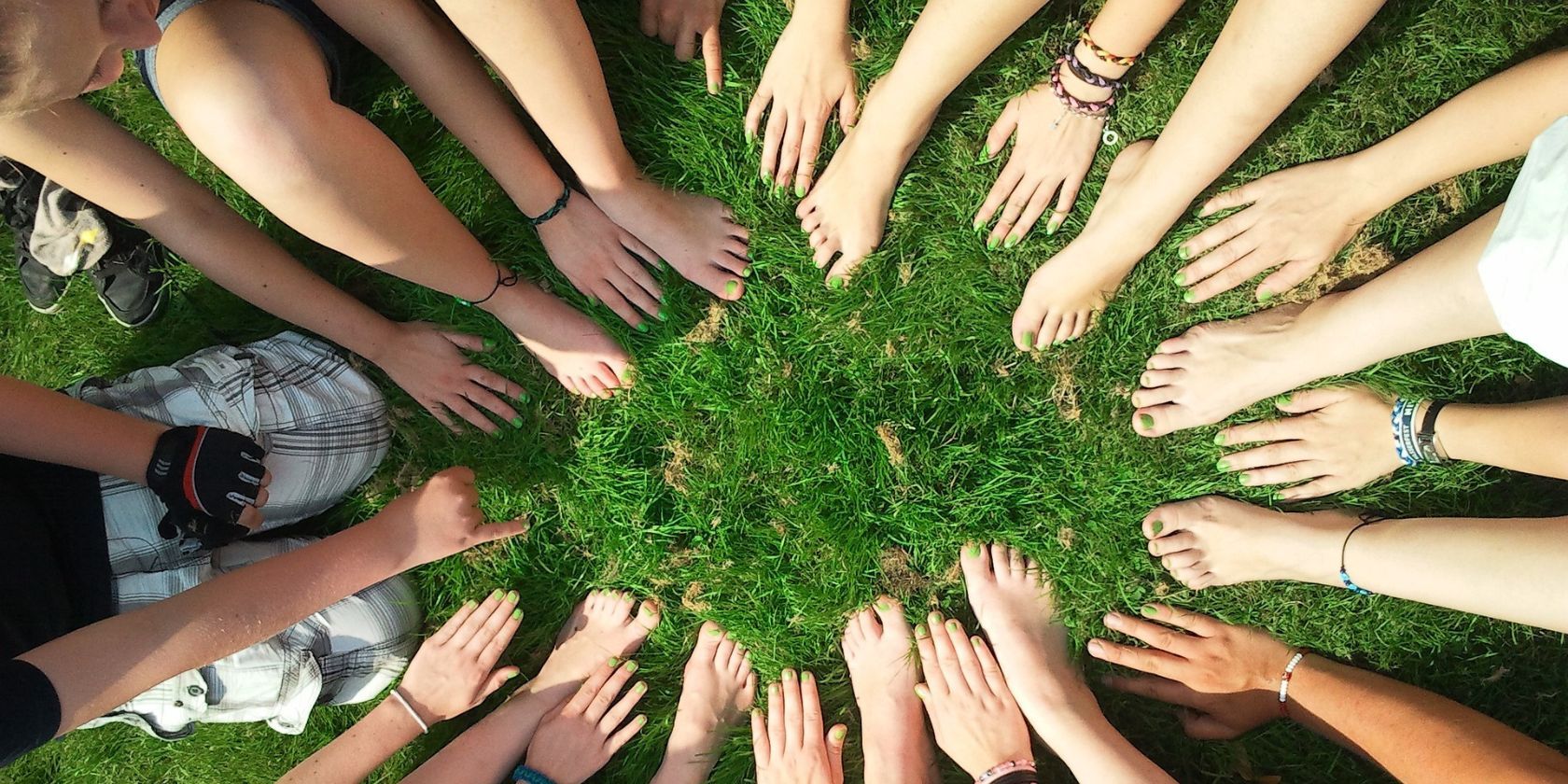 A group of people holding their hands out in a circle