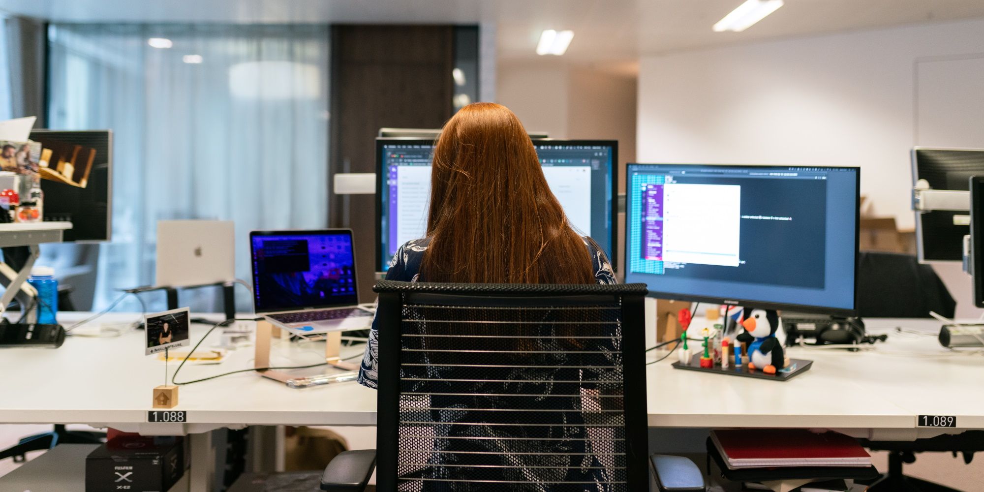woman working with multiple monitors