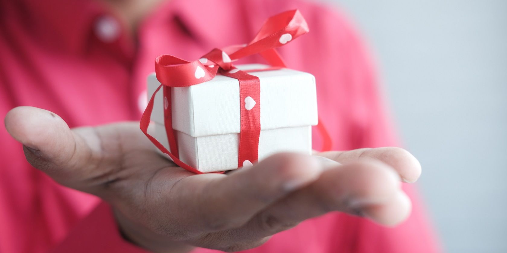 A hand holding a gift box