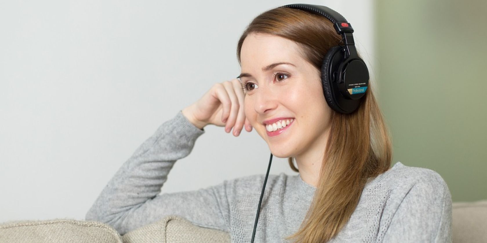 a lady listening to music with headphones on