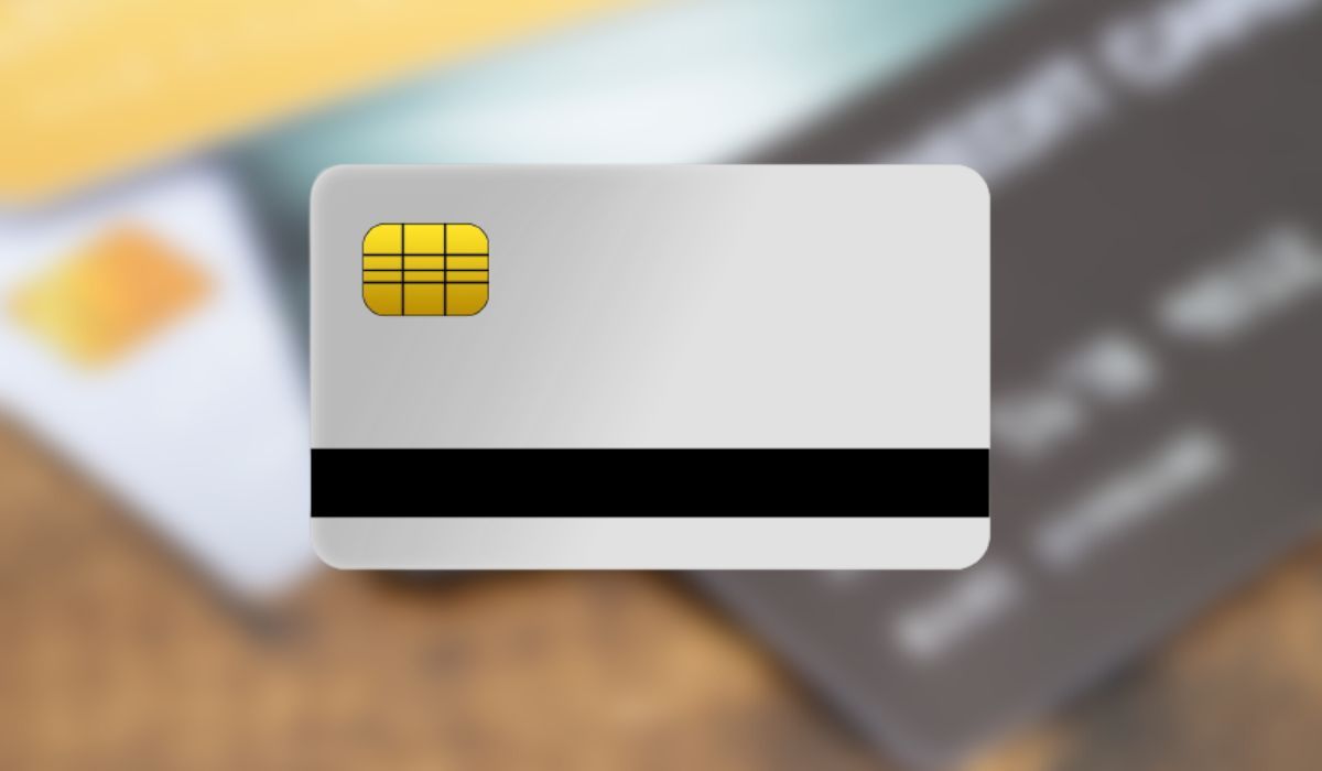 Credit card illustration seen over a blurred photo of credit cards