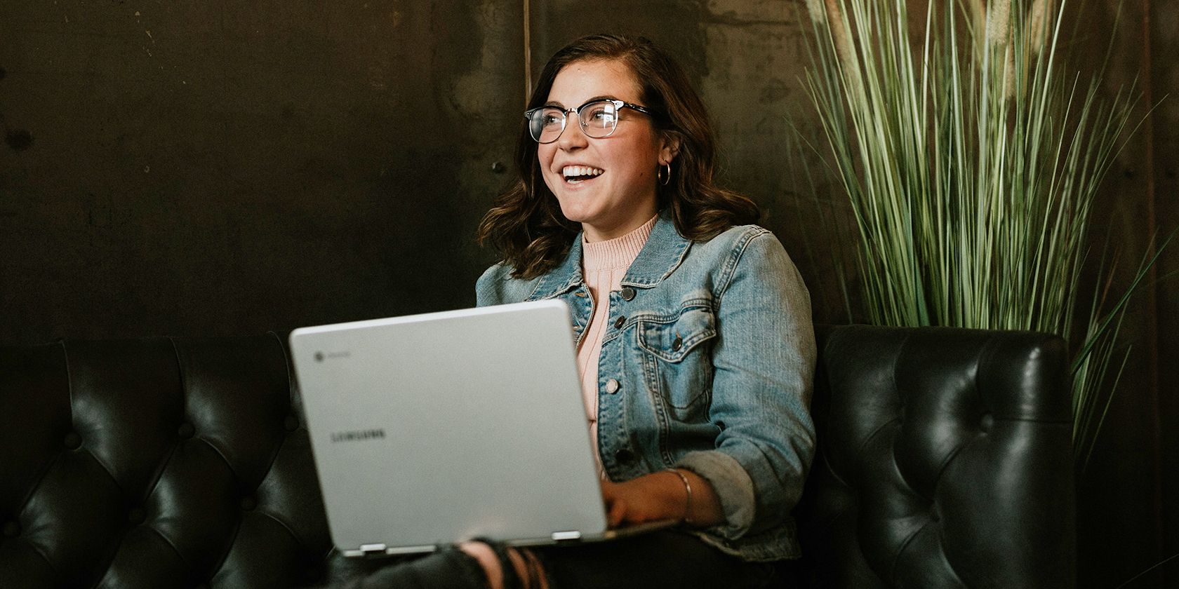 Woman using laptop and smiling