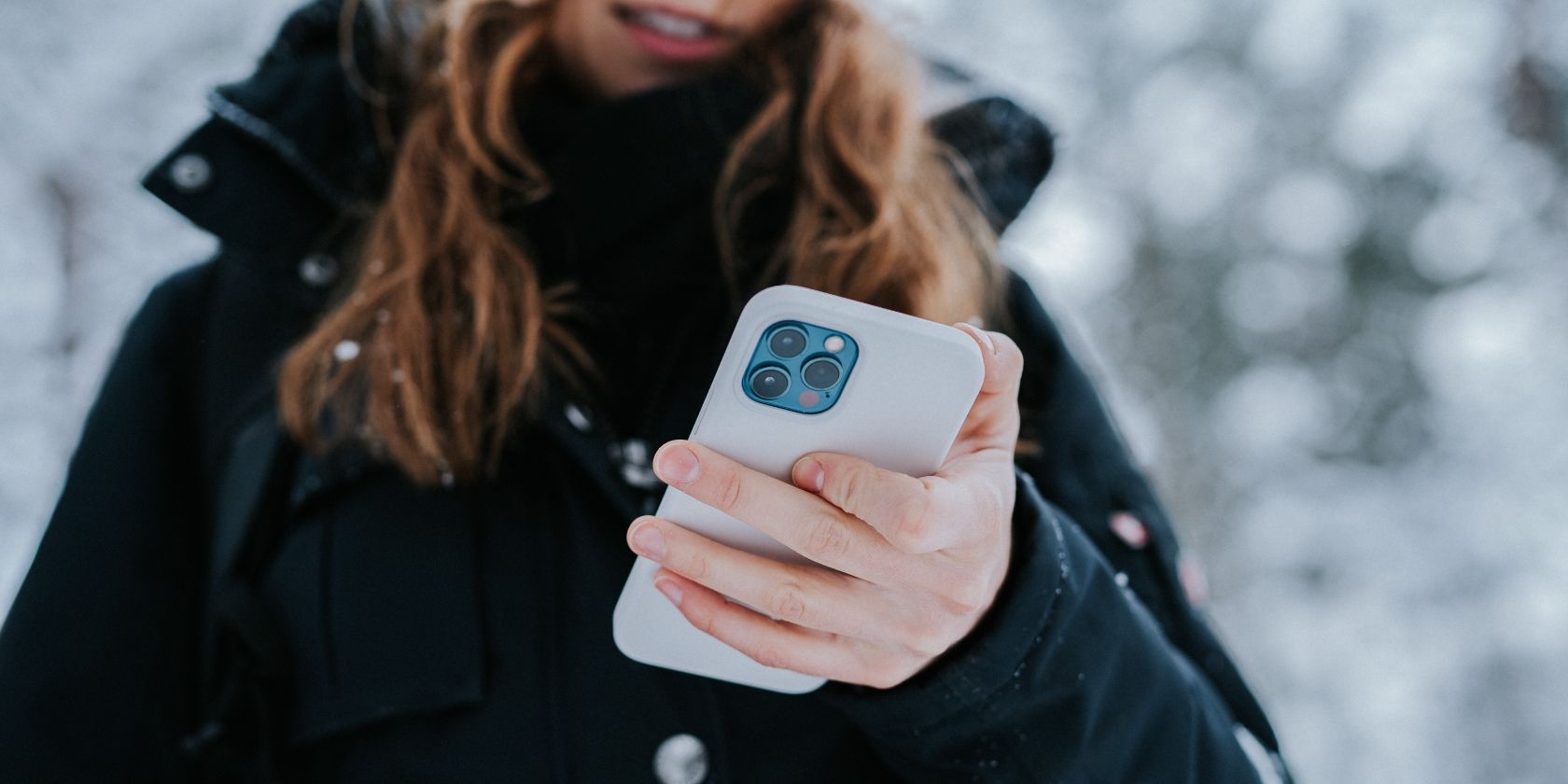 Apple blue iPhone 12 white case woman outside snowy day