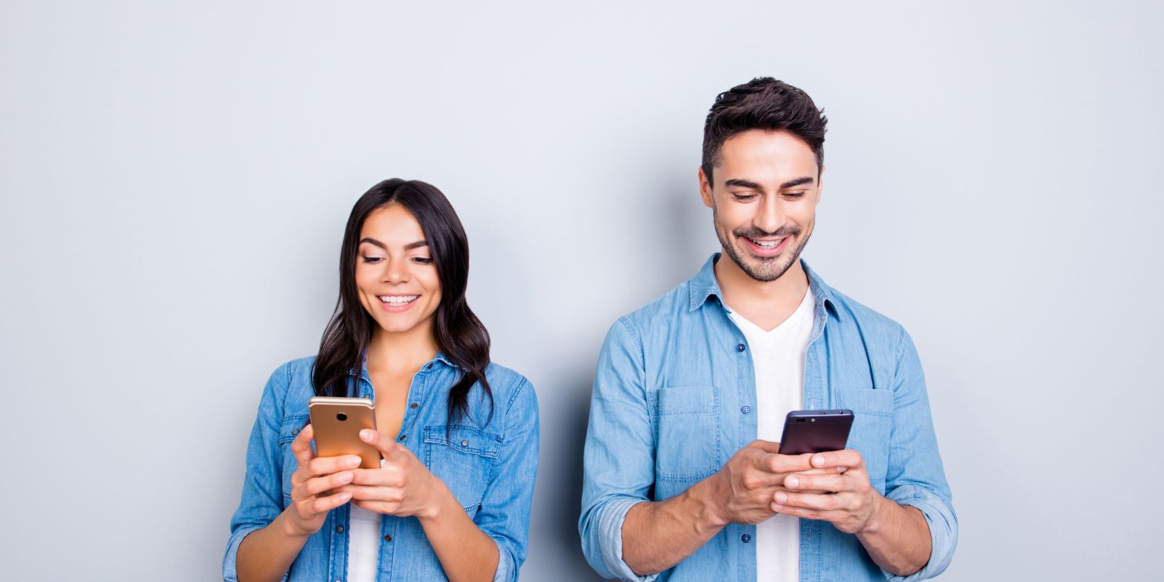 Happy woman and man using smartphones