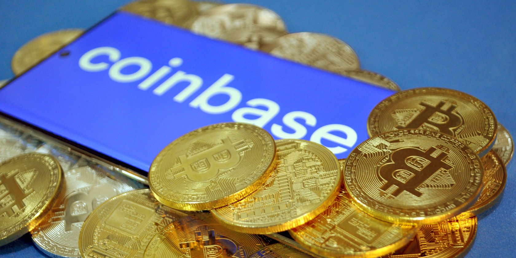 coinbase logo with bitcoins around feature