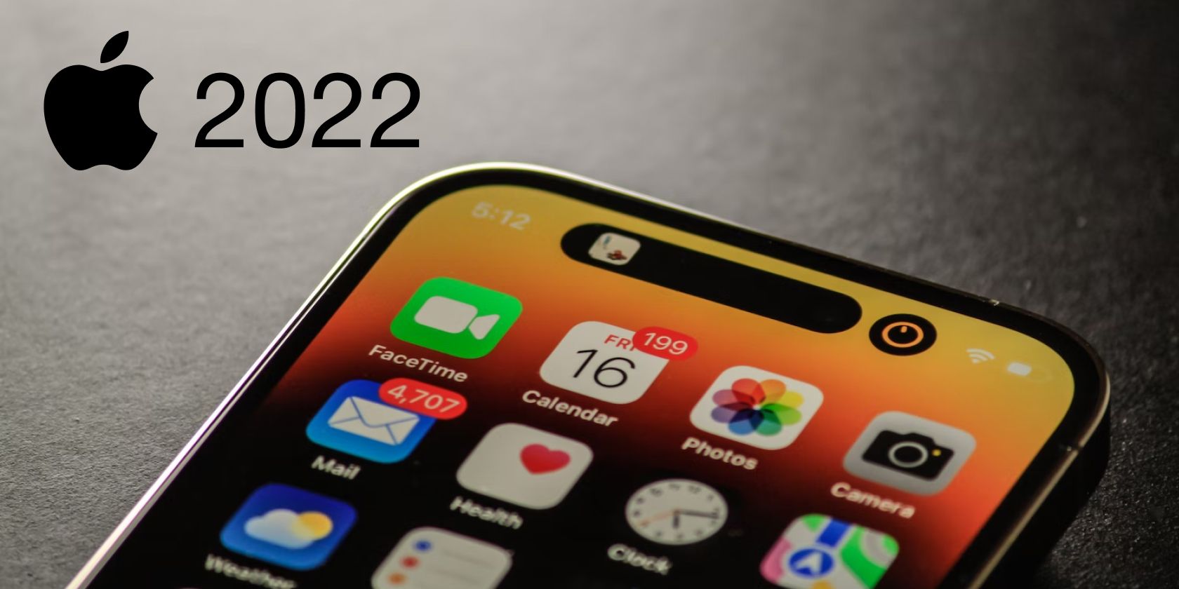 iPhone 14 Pro on table with Apple logo and 2022 text on top-left