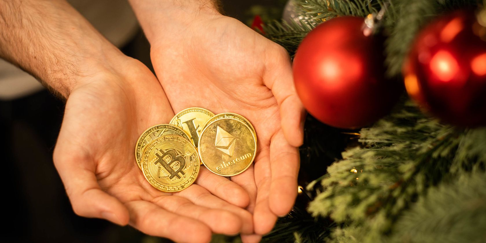 crypto coins next to a christmas tree with baubles