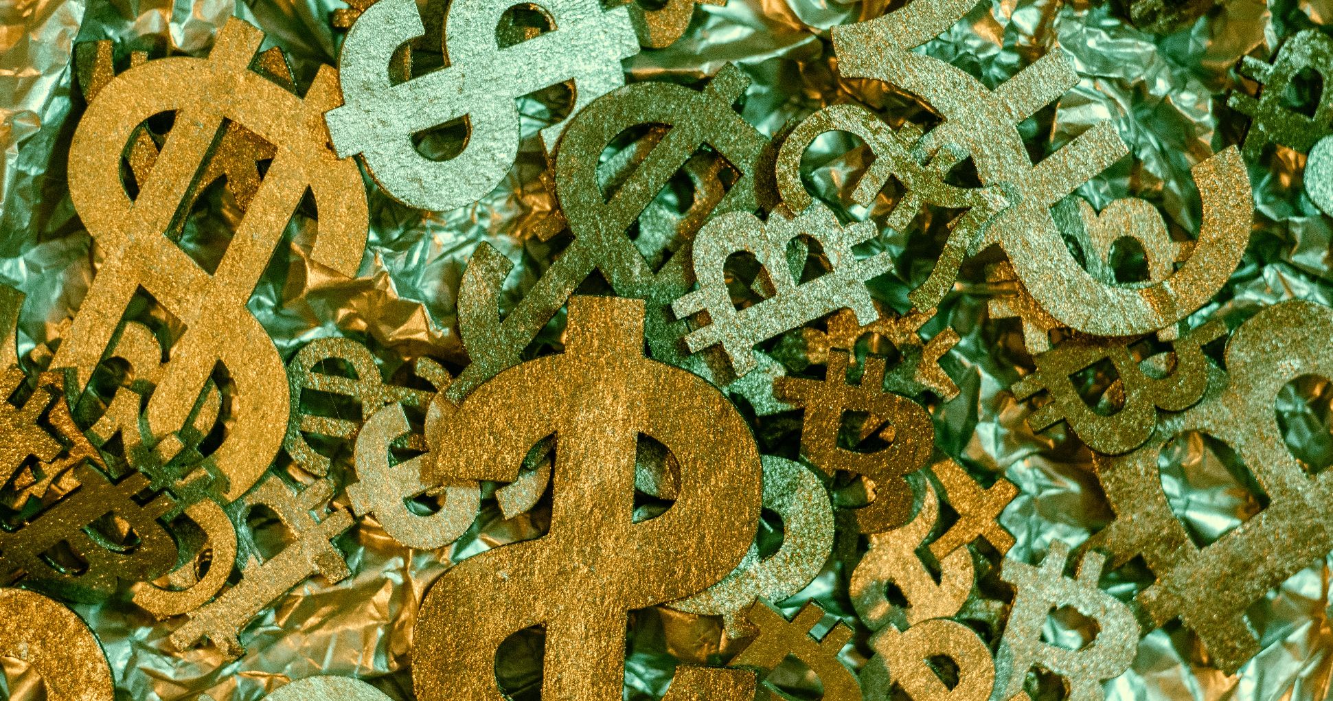 various currency signs in a stack