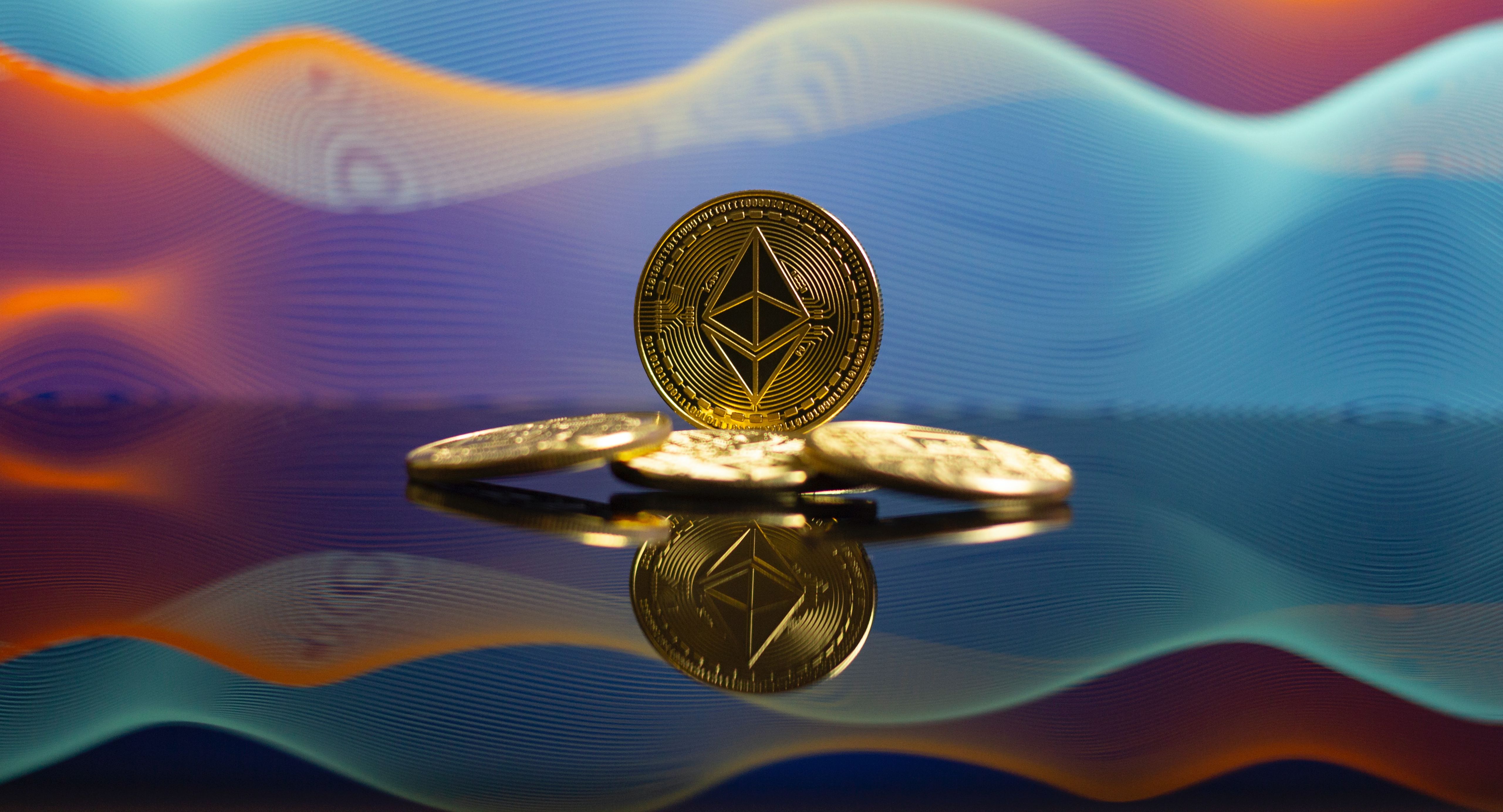 ethereum gold coins in front of wavy background