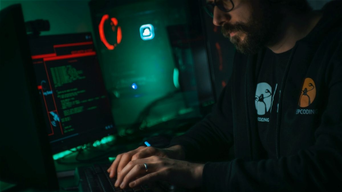 man working on computer programming