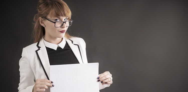 Image of a woman displaying a piece of paper