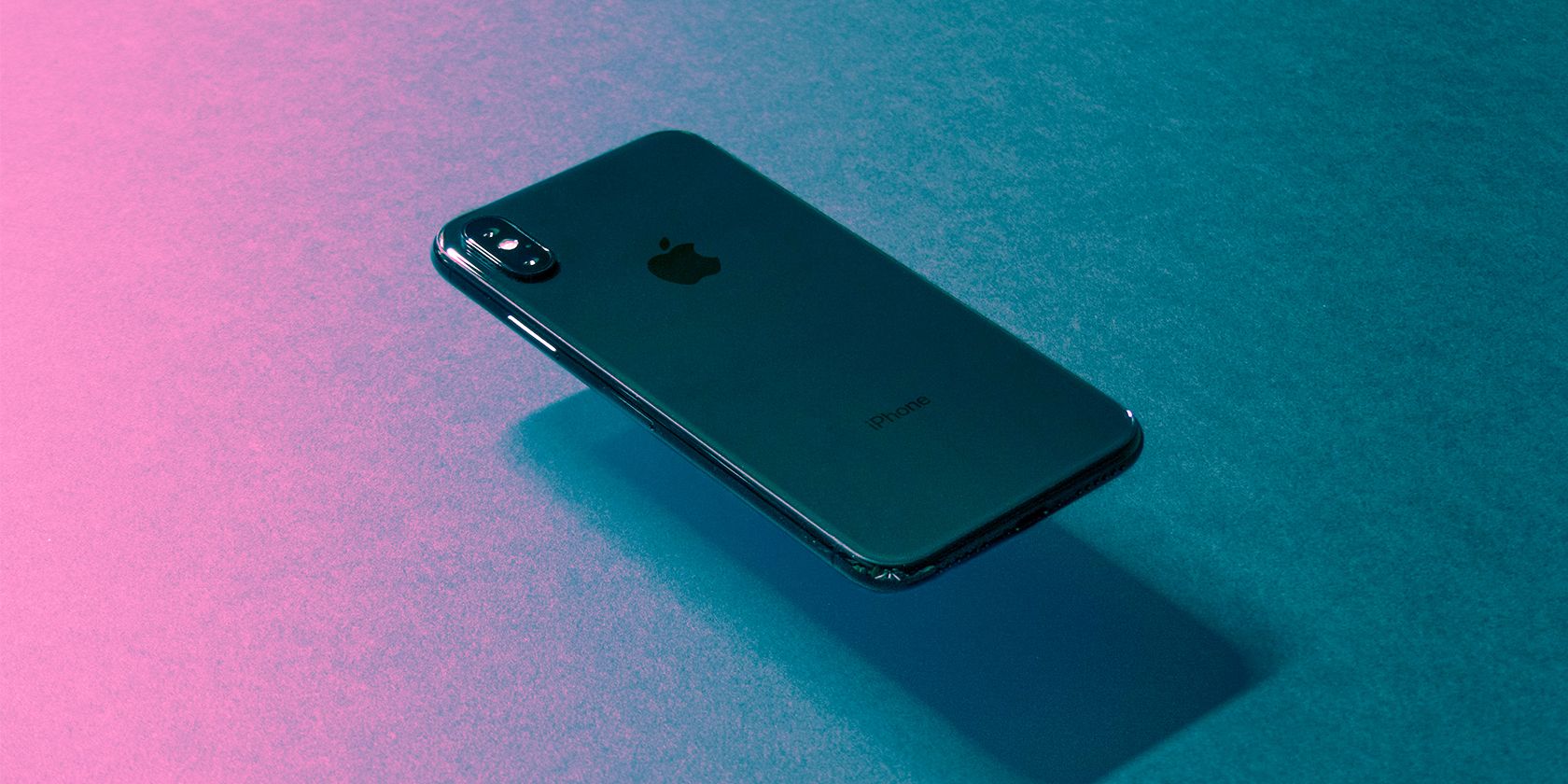 iPhone X floating on a dark background