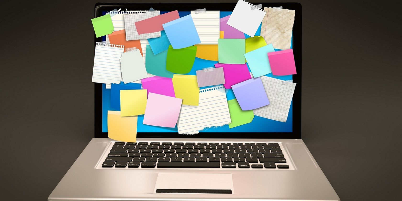 A laptop with sticky notes covering the display