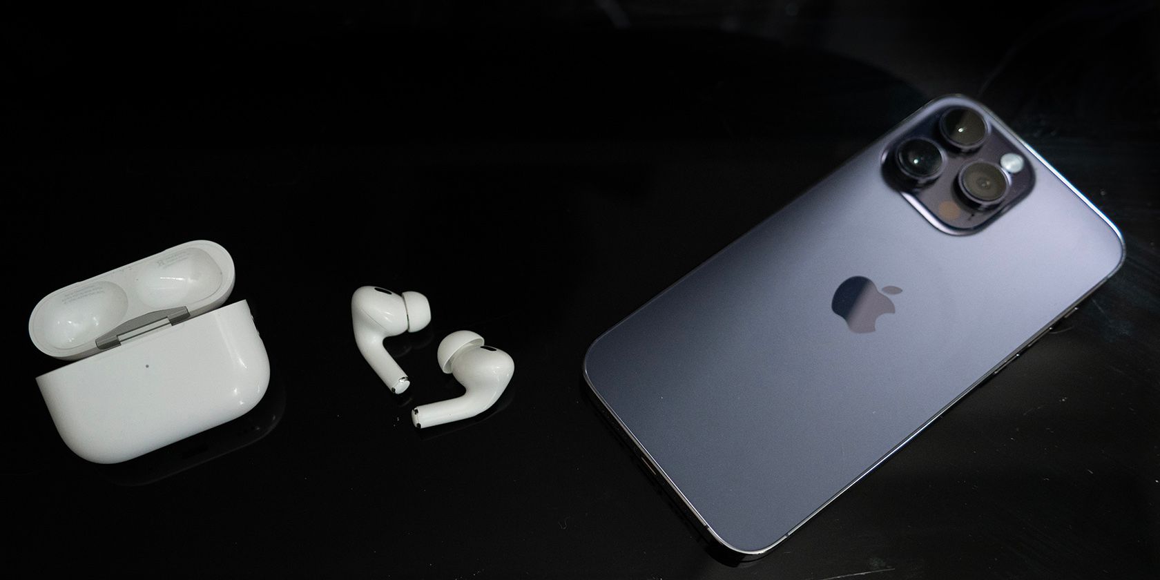 AirPods Pro second generation, open case, and iPhone 14